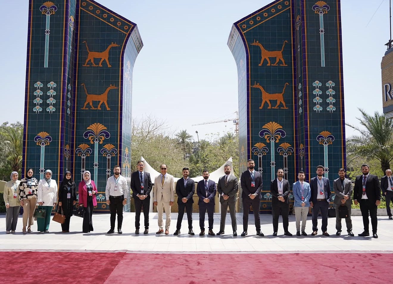 The first Clinical Cardiology Board resident cohort standing before an Iraqi architectural gateway.